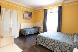 Postel nebo postele na pokoji v ubytování Cervara Park Hotel