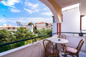 a balcony with a table and chairs and a view at Hotel Calypso in Hanioti