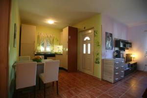 a kitchen with yellow walls and a table and chairs at Raj Muraj Ferienappartement in Kornić
