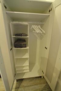a walk in closet with white shelves at Grochowa in Białystok