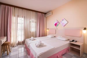 Ένα ή περισσότερα κρεβάτια σε δωμάτιο στο Hotel Calypso