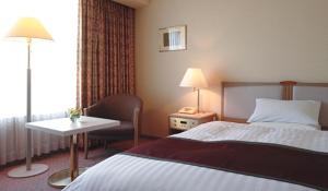 Postel nebo postele na pokoji v ubytování Miyako Hotel Yokkaichi