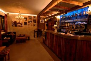 a bar in a restaurant with a bar counter at Bergchalet Hotel Reinerhof in Riva di Tures