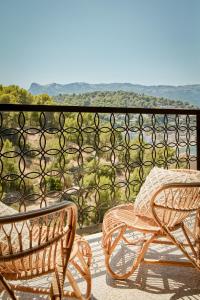 two wicker chairs sitting on a balcony with a view at Bikini Island & Mountain Port de Soller "Adults only" in Port de Soller