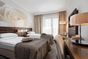Postel nebo postele na pokoji v ubytování Hotel Różany Gaj - Destigo Hotels