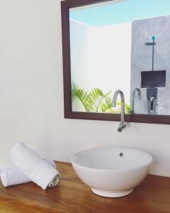 a bathroom with a white sink and a mirror at Swell in El Paredón Buena Vista