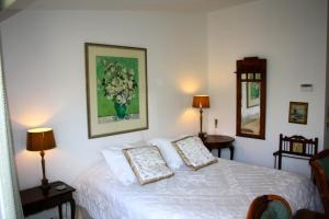 a bedroom with a white bed with two pillows at Villa 't Haasduin in Wijk aan Zee