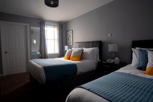 a hotel room with two beds and a window at Wilde Ballybunion in Ballybunion
