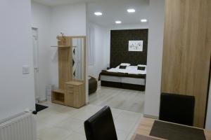 A bed or beds in a room at Wolf House Apartman