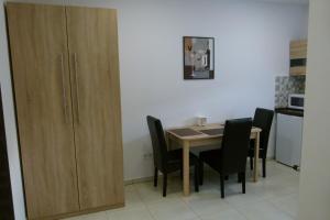 A kitchen or kitchenette at Wolf House Apartman