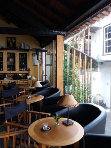 a restaurant with tables and chairs and windows at Casa do Sr. Falcão in Miranda do Corvo