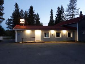 a white building with lights on top of it at Hostel Tikka in Rovaniemi