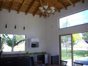 a kitchen with white walls and a ceiling with windows at Villas Premier in Tequisquiapan