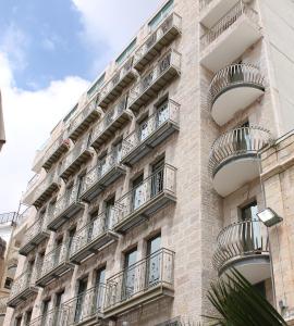 an apartment building with balconies on the side of it at Arthur Hotel - an Atlas Boutique Hotel in Jerusalem