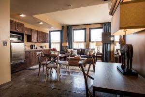 een keuken en een woonkamer met een tafel en stoelen bij Frontier Hotel Pawhuska in Pawhuska