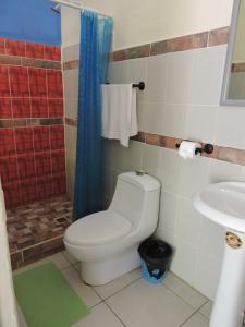 a bathroom with a toilet and a sink at El Portal De Champey in Lanquín