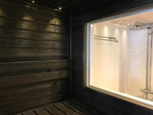 a bathroom with a shower with a window and a tub at Koskenselän Lomakylä in Puumala +146 photos