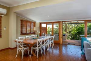 a dining room with a table and chairs at Noosa Beachhouse in Noosa Heads