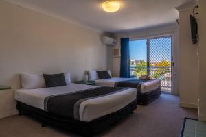 A bed or beds in a room at Chermside Court Motel