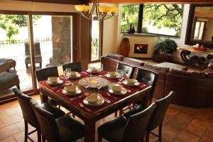 a dining room with a table and a couch at Casa Toscana - Coronado 18 in San Miguel de Allende