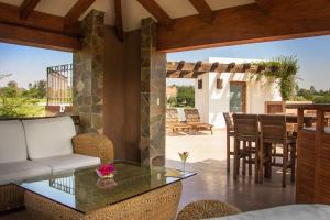 a living room with a glass table and chairs at Casa Toscana - Coronado 18 in San Miguel de Allende