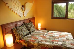 a bedroom with a bed with an angel headboard and two lamps at Casa Toscana - Coronado 18 in San Miguel de Allende
