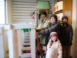 a group of people standing in front of a tiny house at Hakuba M&auml;rchen House in Hakuba
