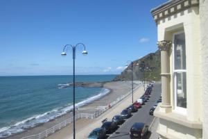 a street with cars parked on the beach at The Glengower in Aberystwyth