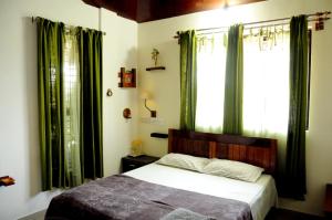 A bed or beds in a room at Cornwall Coorg