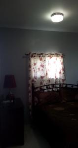 a bedroom with a bed and a lamp at DB Tower Vacation Rental in Belize City