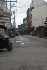 an empty street with a motorcycle parked on the road at Sewak Lodge in Silchar