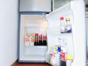 an open refrigerator filled with drinks and condiments at Private House Sora / Vacation STAY 1123 in Sakai