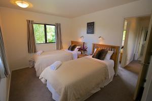 a room with three beds and a window at Crescent House in Wanaka