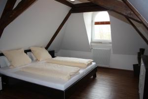 a large bed in a room with a window at Thai Tawan in Rheinhausen