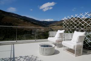 3 weiße Stühle auf einem Balkon mit Aussicht in der Unterkunft LBV House Hotel in Pinhão + 37 Fotos