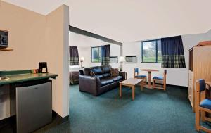 a living room with a couch and a table at Super 8 by Wyndham Spearfish in Spearfish