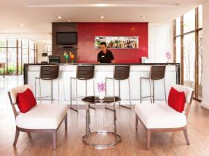 a man standing at a bar in a kitchen at Ibis Bangkok Riverside in Bangkok