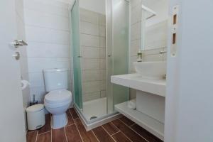 a bathroom with a toilet and a shower and a sink at River View Boutique Apts in Ayia Napa