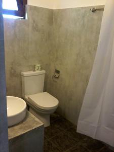 a bathroom with a white toilet and a sink at Secret Palace Guest house in Galle