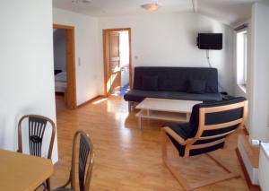 a living room with a couch and a table and chairs at Hotel Stadt Coblenz in Fachbach