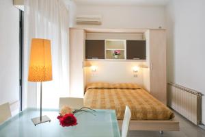 a bedroom with a bed and a glass table at Residence Internazionale in Rimini