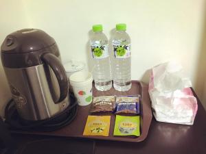 a table with a tea kettle and two bottles of water at Dongyin First Homestay in Dongyin/