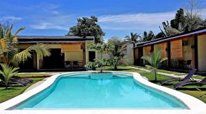a swimming pool in the yard of a house at Positano Alona Beach Panglao in Panglao