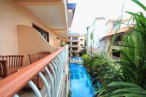 a balcony with a swimming pool and plants at Baan Boa Resort in Patong Beach
