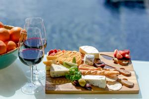 a plate of cheese and meats and a glass of wine at Belvoir Pavilions near Berry in Berry