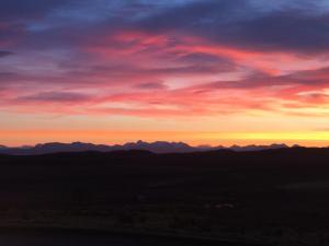 a sunset with mountains in the background at An Cnoc Bed & Breakfast in Staffin