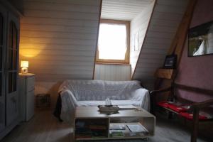 a living room with a couch and a table at Pesaulhé in Monein