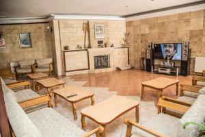 a living room with a fireplace and a tv at Reis Thermal Otel in Pamukkale