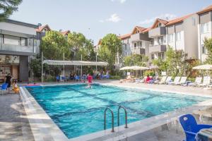 uma piscina num hotel com pessoas a brincar nela em Reis Thermal Otel em Pamukkale