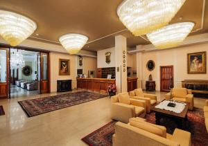 a living room filled with furniture and a fire place at Grand Hotel Excelsior in Chianciano Terme